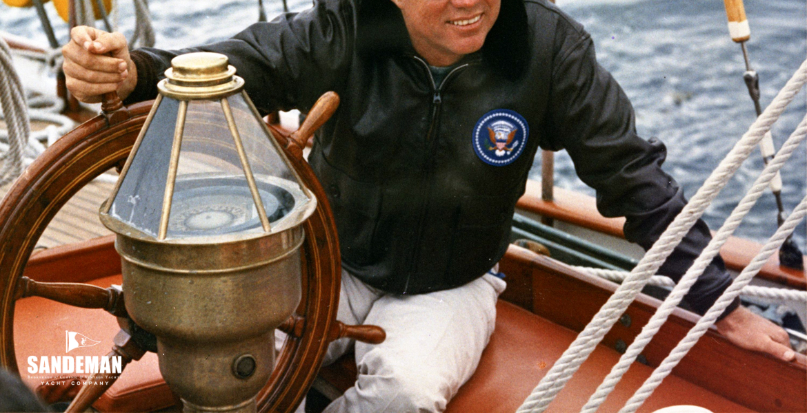 JFK at the helm [PHOTO: Robert Knudsen. White House Photographs. John F. Kennedy Presidential Library and Museum, Boston]