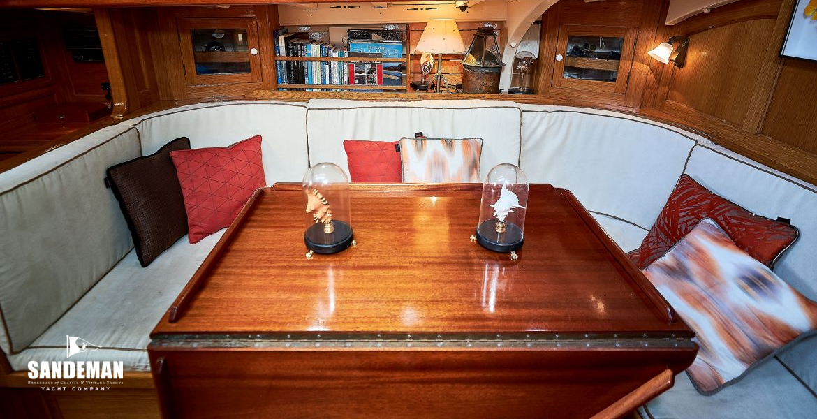Saloon table, seating and shelves to port