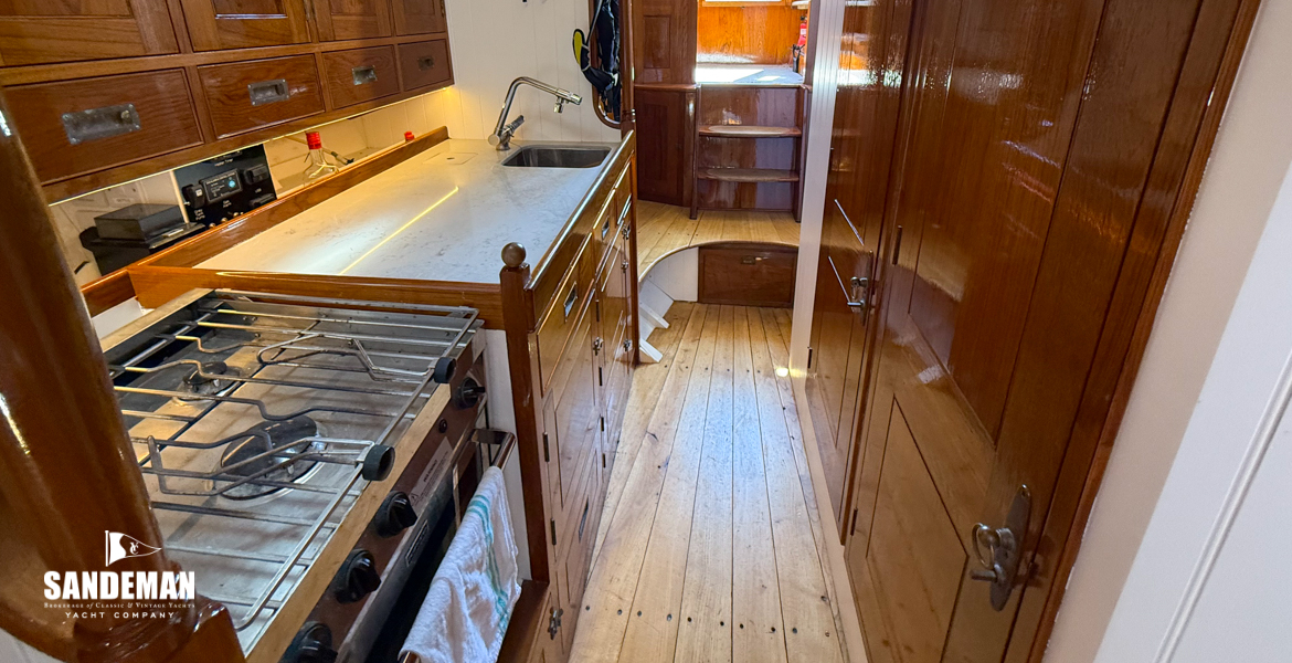 Passage aft, galley to stbd, heads to port