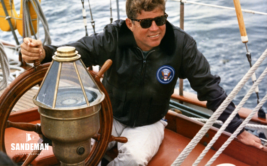 JFK at the helm [PHOTO: Robert Knudsen. White House Photographs. John F. Kennedy Presidential Library and Museum, Boston]
